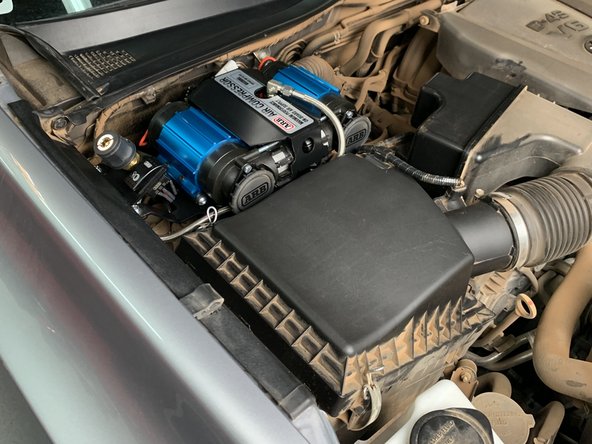 Toggle the compressor switch to the on position. The compressor should turn on for a short period of time then turn off.