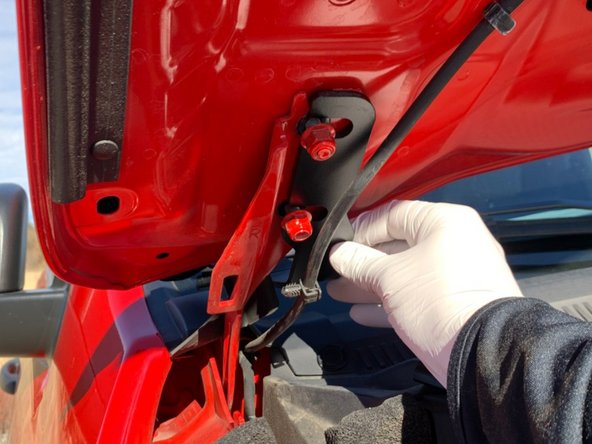 There is a left and right hood hinge light bracket. Make sure you have the correct bracket for the side you are installing. The brackets install from the center of the vehicle out, with the slots sliding over the hood studs as shown.
