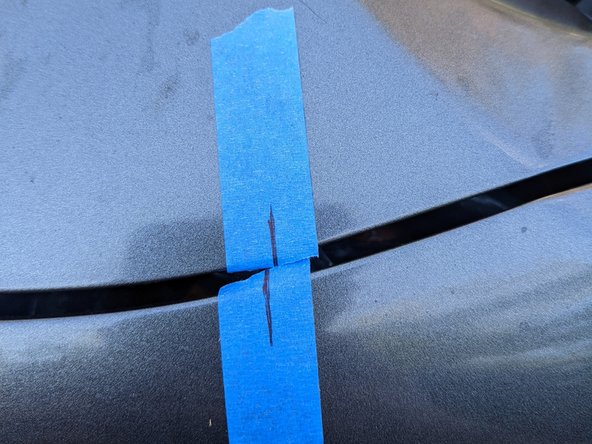 Carefully close the hood, noting the alignment marks compared to the starting position.