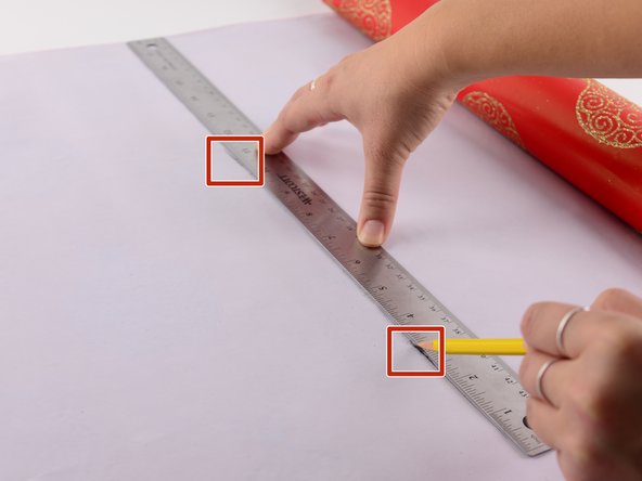 Move the present out of your way, off of the wrapping paper.