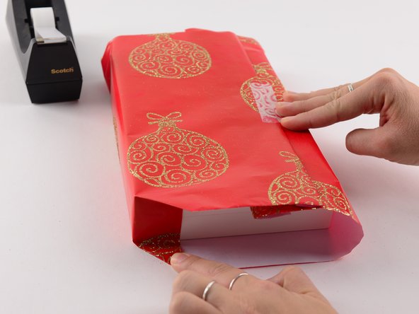 On the bottom and top of present—where the box is still exposed—you'll make several folds.