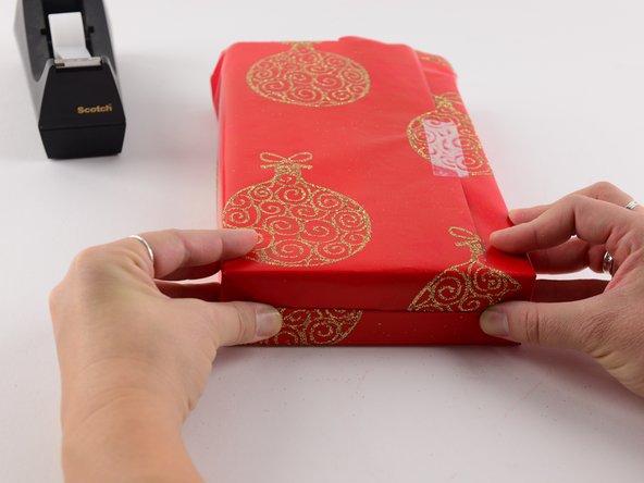 While holding the top fold down, bring the bottom fold up.