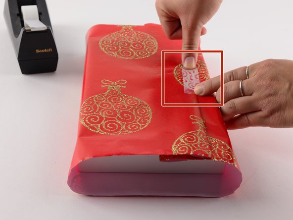 Pull the paper tight so the present is snug.