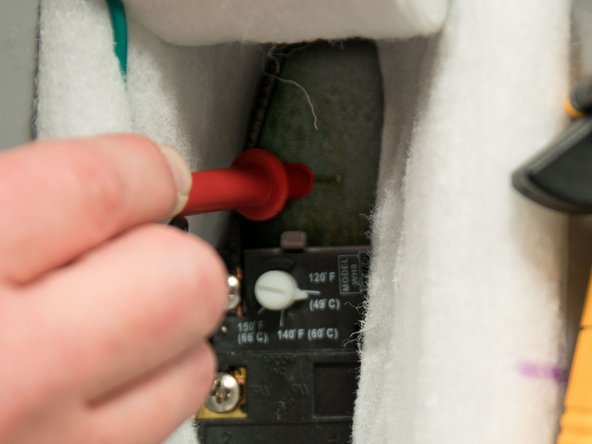 Check for a short between each heating element screw and the inner steel tank.