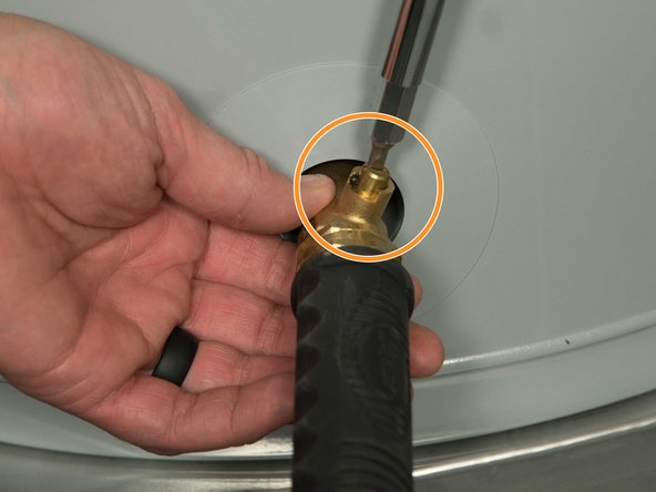Some drain valves may be opened with a handle but others require a flat-blade screwdriver. 