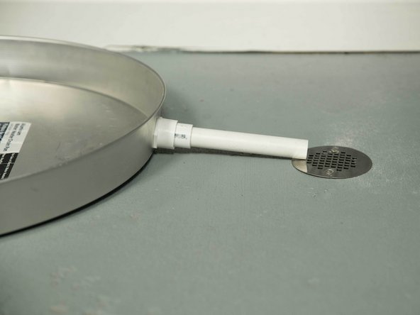 The drain pan must be at least two inches wider than the diameter of the water heater.