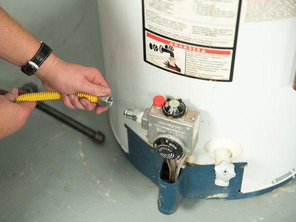Disconnect the gas pipe from the old water heater's control valve.
