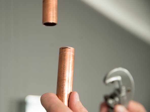 Cut both of the water pipes, but leave them a little longer than the measurement. You can always cut them shorter if necessary.