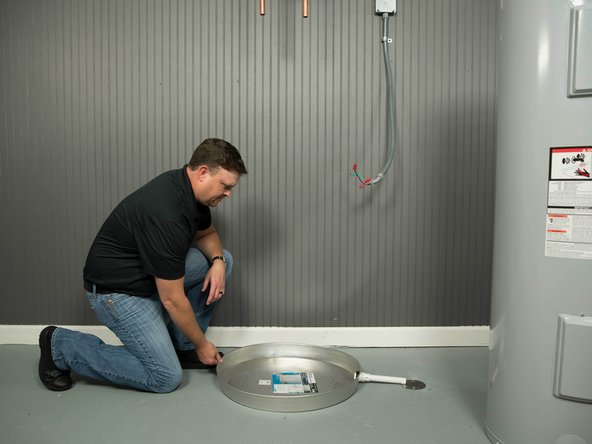 The drain pan must be at least two inches wider than the diameter of the water heater.