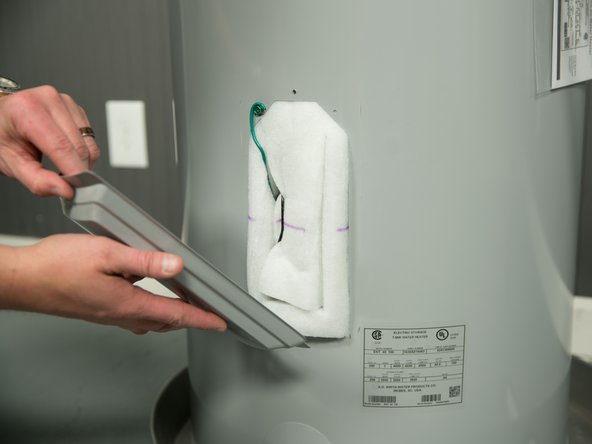 Remove the upper or lower heating element cover.