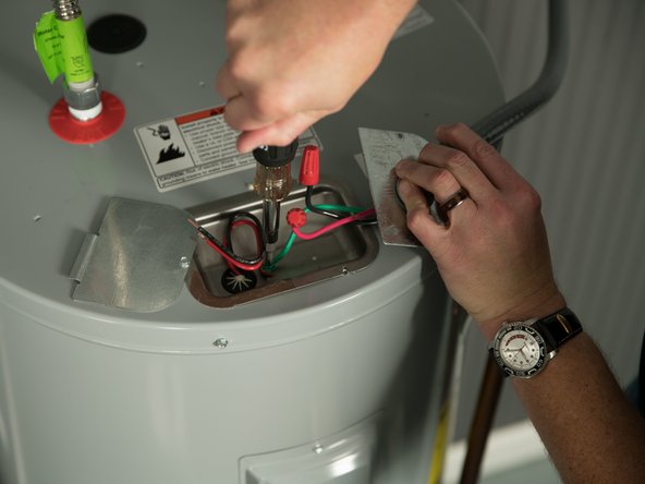 Connect the home's bare copper or green ground wire to the water heater's green ground screw.
