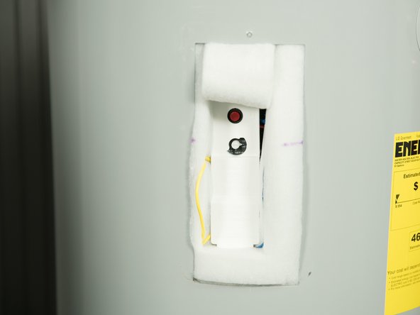 Carefully fold back the insulation (tuck the insulation under the water heater's jacket).