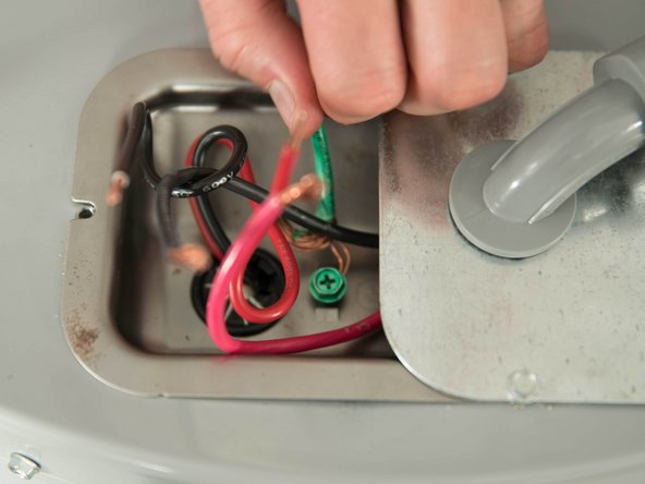 Unscrew the water heater's green ground screw and disconnect the ground wire.
