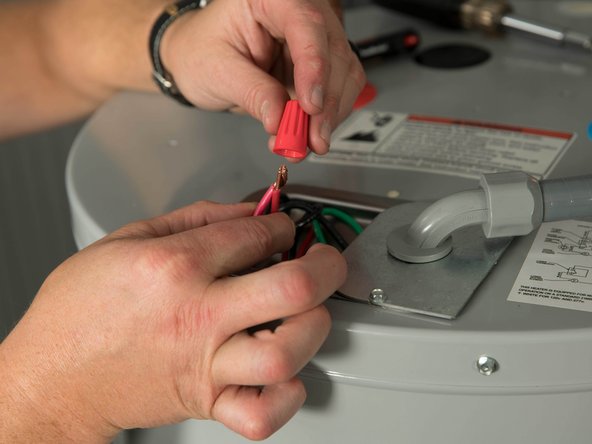Unscrew the wire nuts connecting the water heater's service wires and home's power wires.