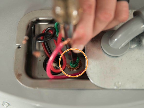 Connect the home's bare copper or green ground wire to the water heater's green ground screw.