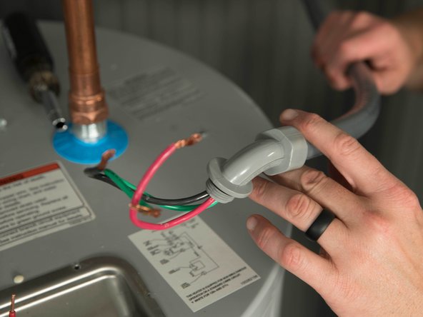 Disconnect the strain relief and save it for use with the new water heater.