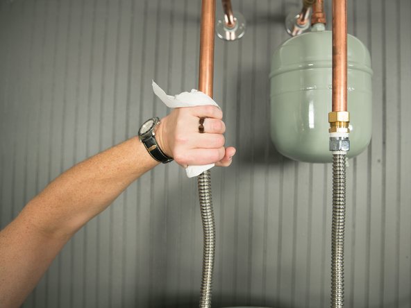 Using a fresh, dry paper towel, press the paper towel against the inlet and outlet connections and check for water droplets or moisture.