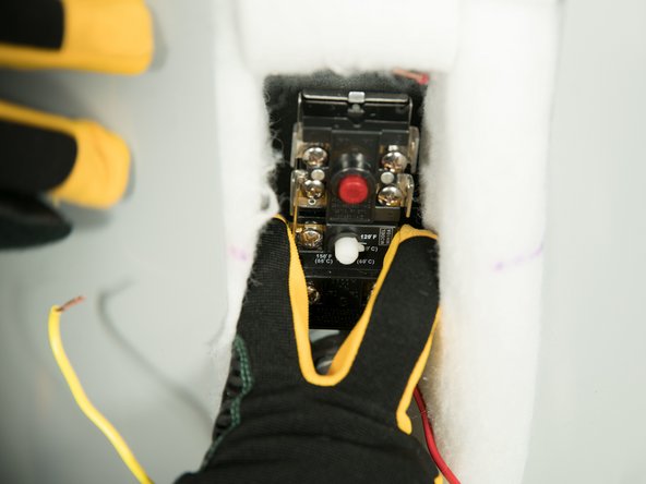 Install the new thermostat in the metal mounting clip.