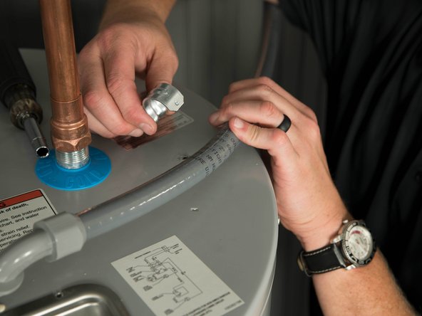 Disconnect the strain relief and save it for use with the new water heater.