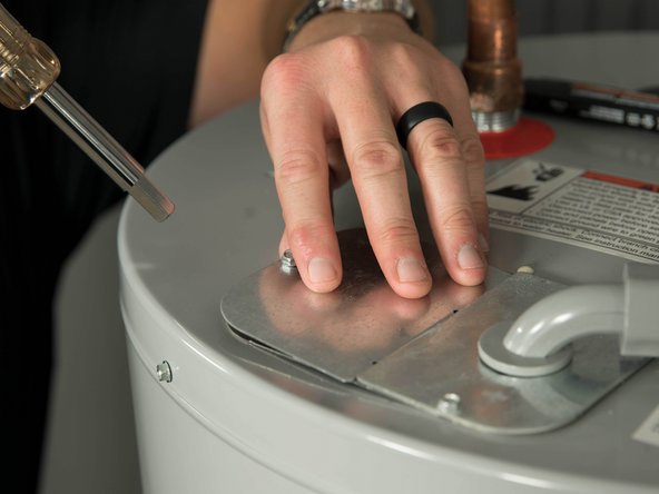 Open the electrical junction box on top of the water heater.
