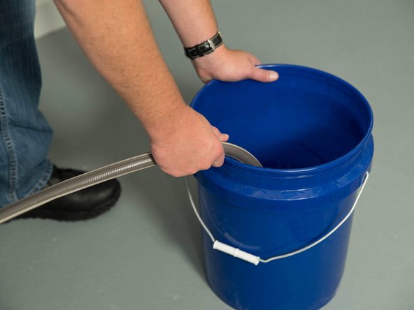 Connect a garden hose to the water heater's drain valve and place the other end of the hose in a drain, outside, or in a bucket.