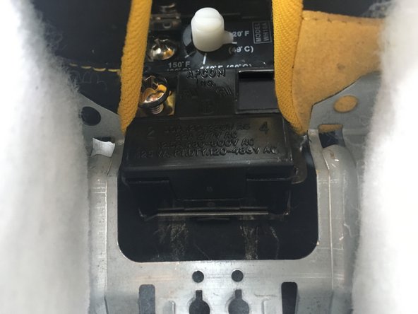 Install the new thermostat in the metal mounting clip.