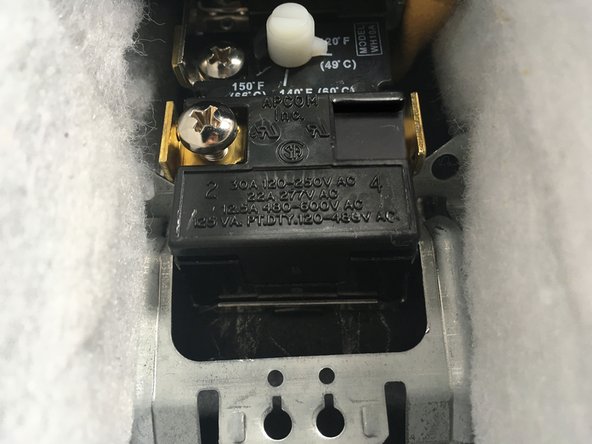 Install the new thermostat in the metal mounting clip.