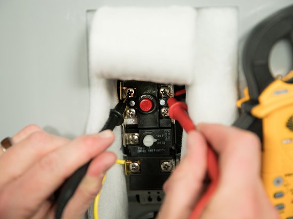 Check the voltage at the top two screws of the upper thermostat.