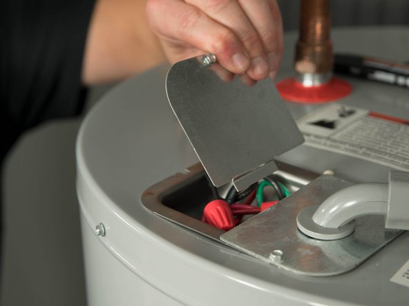 Open the electrical junction box on top of the water heater.