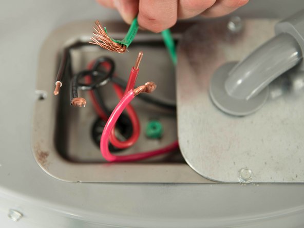Unscrew the water heater's green ground screw and disconnect the ground wire.