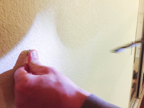 Insert wall anchors in the holes.