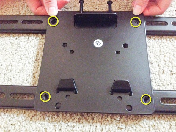 Attach TV mount plate to the TV mounting bracket.