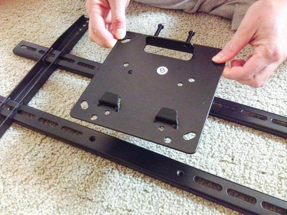 Center the TV mount plate on the horizontal lengths.