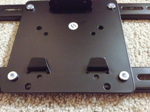 Attach TV mount plate to the TV mounting bracket.