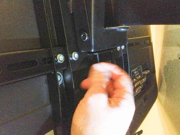 Tighten the TV mount plate screws to hold the bottom of the plate in place.