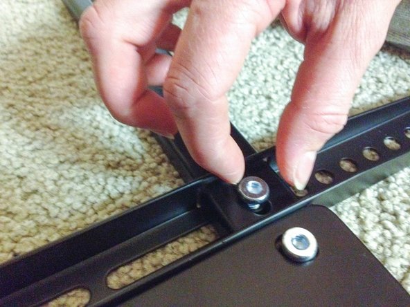 To complete the assembly of the TV mounting bracket secure the TV mounting bracket with a screw in each corner.