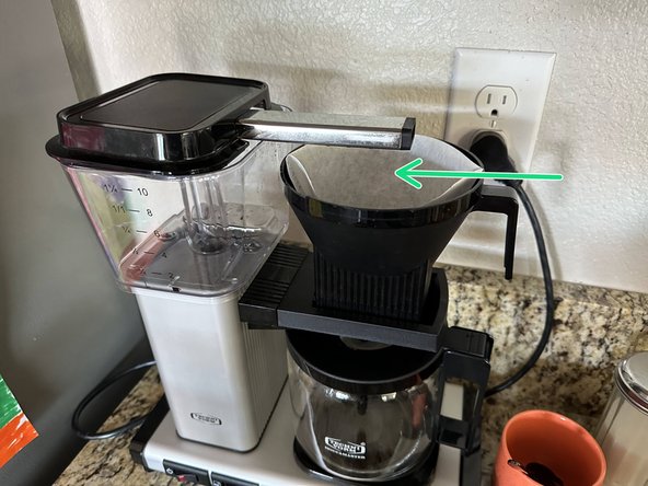 Insert the filter basket above the water pitcher. The basket slides in from left to right.