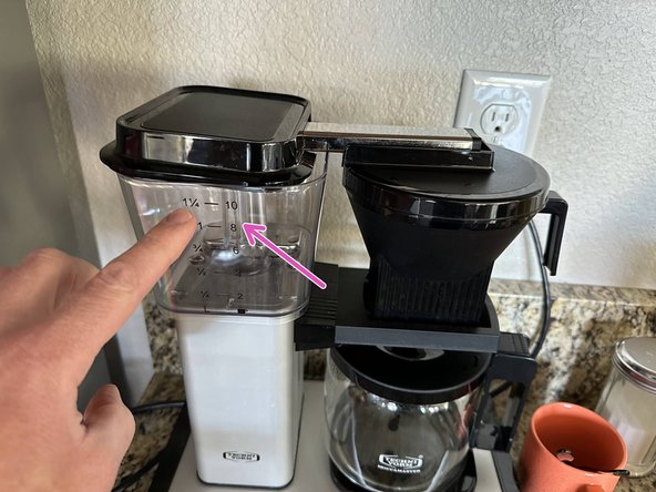 Note: This is an optional step. You may want to leave the lid off and enjoy the sights and smells of fresh water mixing with freshly ground coffee.