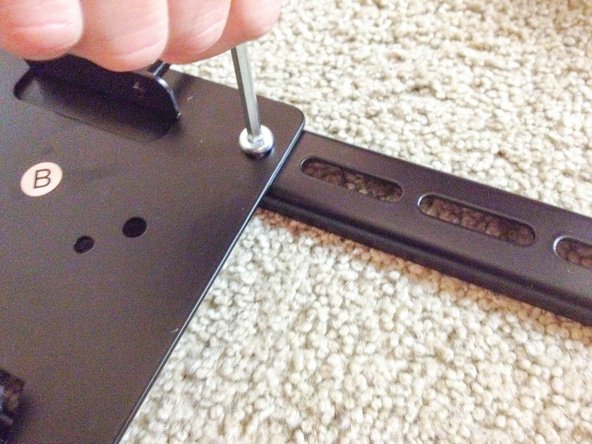 Attach TV mount plate to the TV mounting bracket.