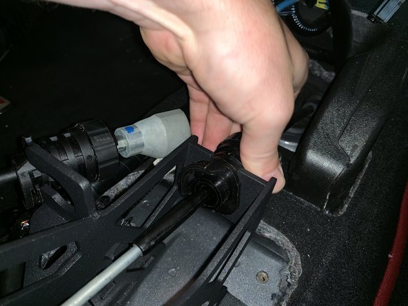 Twist the cable mount and slide it into the shifter.  Make sure you align it correctly otherwise the cables will not slide in.