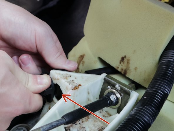 Twist the left shifter cable clockwise and slide it out the side of the shifter.