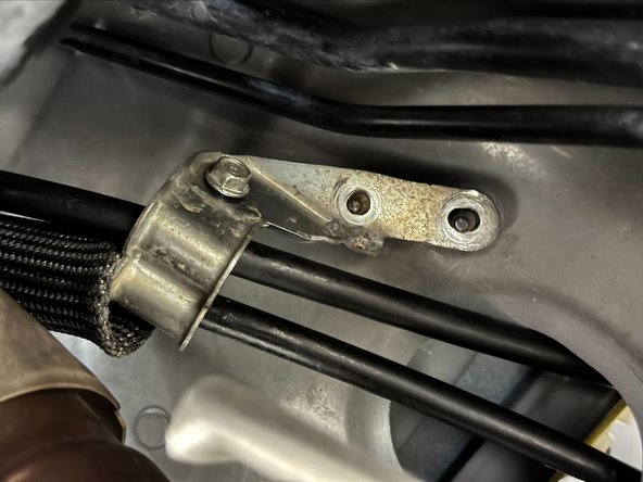 Squeeze bracket closed so that the 10mm bolt can be reinstalled.