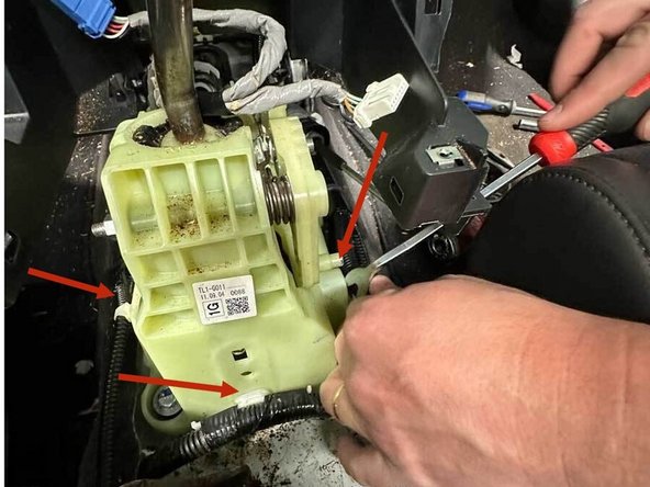 Using a panel popper, remove all of the wiring harness clips attached to the shifter plastic.