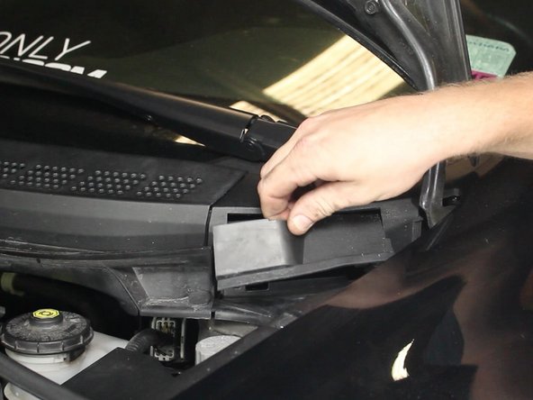 Remove the cover plate to expose the upper strut nuts.