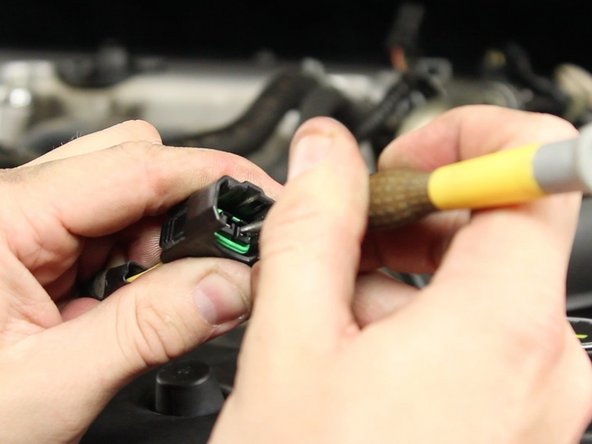 Using a small point pick, pry the pin lock upwards while pulling the wire out of the connector.