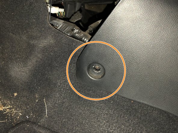 There is one screw on each side of the footwell.