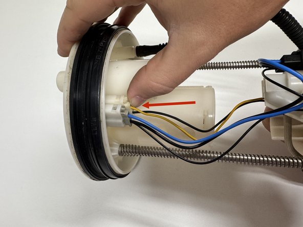 Make sure it routes behind the level sending unit. Clip the hose back into its original position.