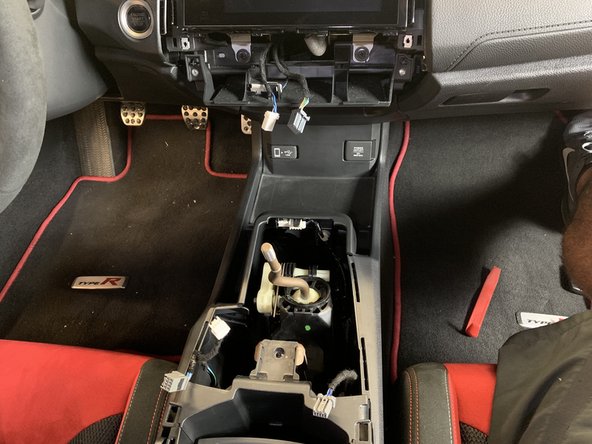 You may need to put your shifter into 4th gear to clear the plastic cover.