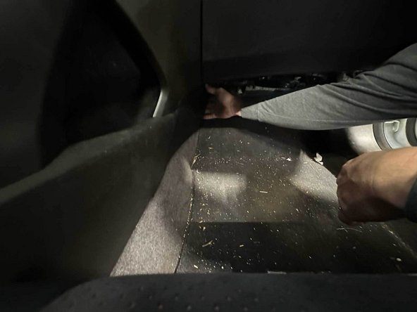 Gently pull at the rear edge and pry upward—the panel clips should release with light pressure.