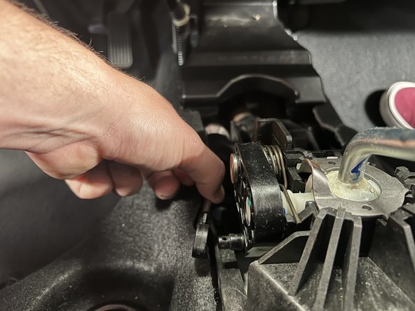 Rotate the shifter cable mount and slide it upward so it comes out of the shifter.